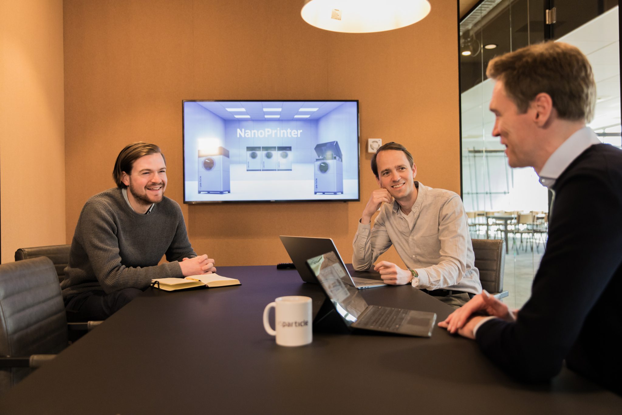 Aaike van Vugt in a meeting room with two colleagues.