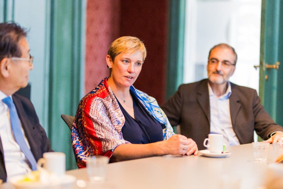 A picture of General manager of JCR Europe Anne Bechet sitting at a table.