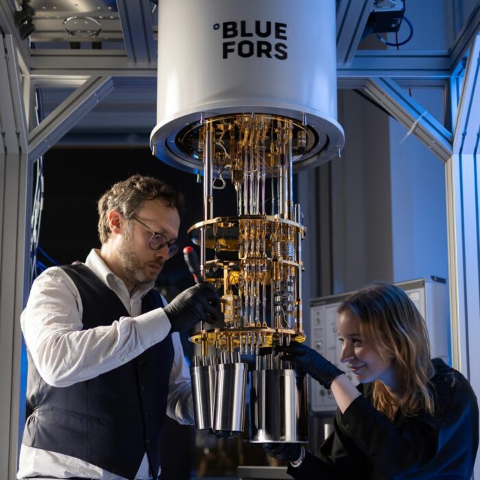 Two employees in the Bluefors lab, working on the ultra-low temperature refrigeration and cryogenic system.