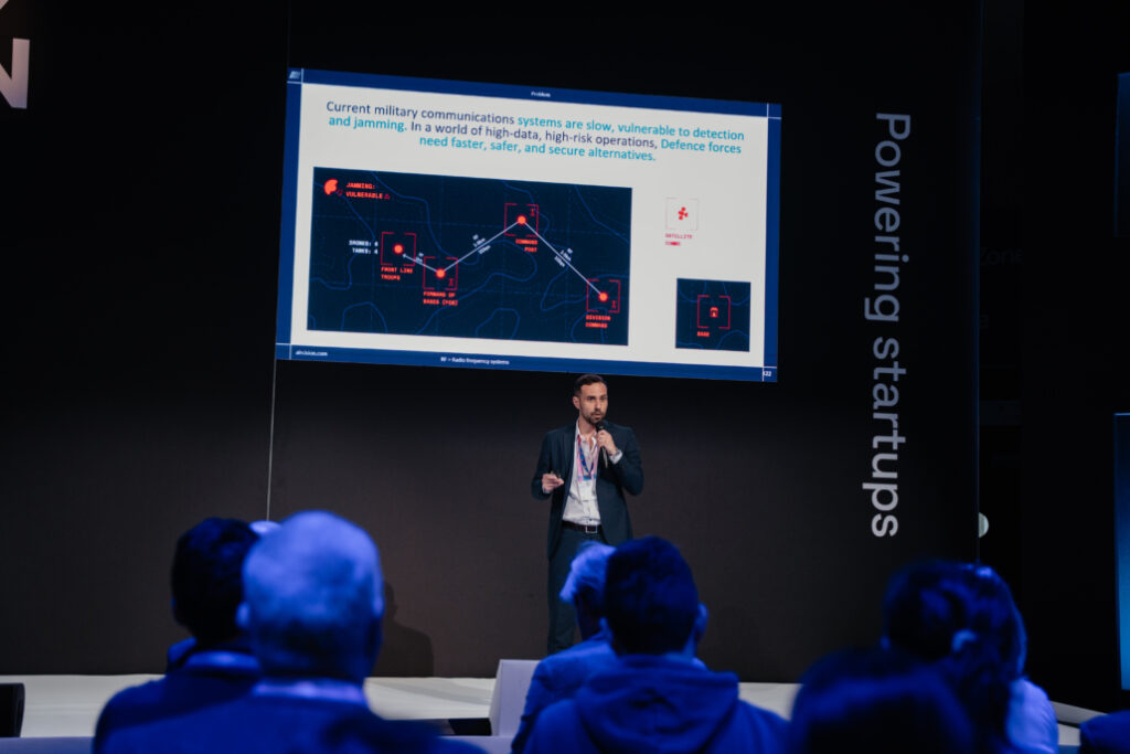 A picture of a man giving a presentation during the first day.