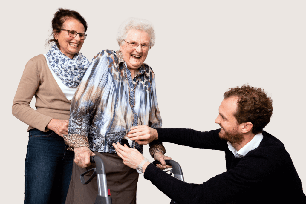 Een foto van een glimlachende Jannie die vast wordt gehouden door Anne-Claire van Altvorst en Matthijs Wiegant.